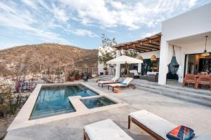 a house with a swimming pool and a patio at Montebello Pool House-3 BD in Los Barriles