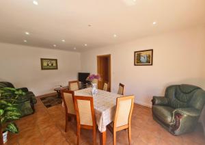 a dining room with a table and chairs at Casa do Telhal in Vila Nova de Gaia