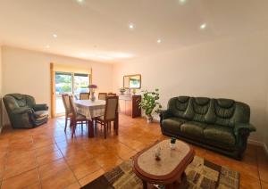 a living room with a couch and a table at Casa do Telhal in Vila Nova de Gaia
