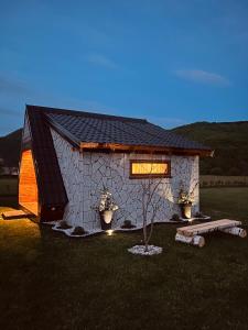 a small building with a window in a field at Plava Zora in Kolašin