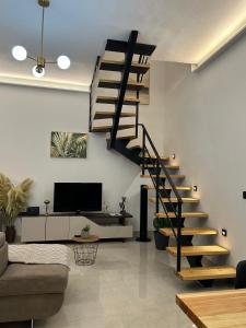 a living room with a spiral staircase in a house at Vista Mare Maisonette in Ipsos