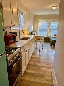 a kitchen with a sink and a stove top oven at Well Located Studio on the Red Line in Chicago