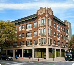 a large red brick building on a city street at Well Located Studio on the Red Line in Chicago