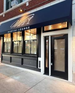 a restaurant with a blue awning on a building at Well Located Studio on the Red Line in Chicago