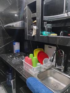 a kitchen sink with dishes in a dish rack at Casa Rota in Mérida