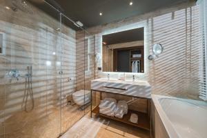 a bathroom with a tub and a sink and a shower at Chic Boutique Hotel Vlore in Vlorë +137 photos