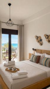 a bedroom with a bed with a view of the ocean at Anthoula House Sarti in Sarti