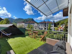 a patio with a table and chairs on a balcony at Holiday Home Mila in Spodnja Idrija