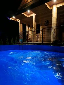 a view of a pool at night at Domki Gorce Klikuszowa Sauna Jacuzzi in Klikuszowa