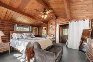 a bedroom in a log cabin with a bed and a couch at Mat-Su Resort in Wasilla