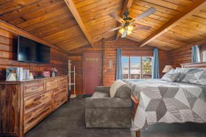 a bedroom with a bed and a ceiling fan at Mat-Su Resort in Wasilla