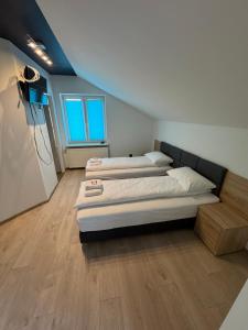 a room with two beds in a room with at Motel Okoń in Orzysz