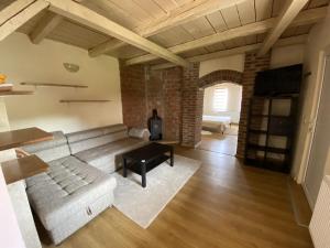 a living room with a couch and a table at Fântânele Vacation Home, Charming Rustic Home in Fîntînele