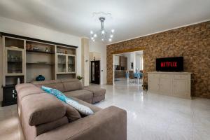 a living room with a couch and a tv at TacchiHousePanorama in Jerzu +25 photos