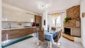 a kitchen with a blue table and chairs in a room at TacchiHousePanorama in Jerzu