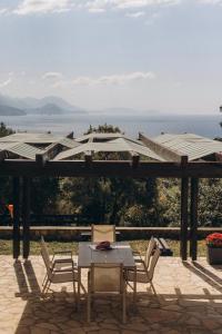 a patio with a table and chairs and an umbrella at Carob Breeze House in Krimovice
