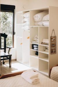 a room with a closet filled with white towels at Carob Breeze House in Krimovice +44 photos