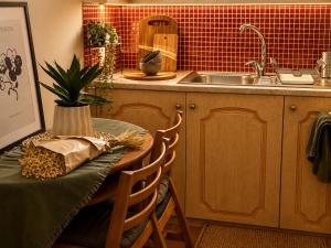 a kitchen with a table and a sink at Kaloudis Studios & Apartments in Dassia +129 photos