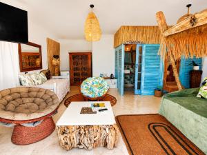 a living room with a couch and a table at VistaBlu Camps Bay in Cape Town