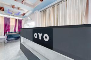 a black and white reception desk in a room with curtains at Hotel O Star Inn in Hyderabad