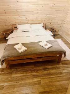 a bedroom with a bed with two towels on it at Villa Antonela Kupres in Kupres +46 photos