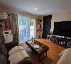 a living room with a couch and a table at Wallace getaway in Delta