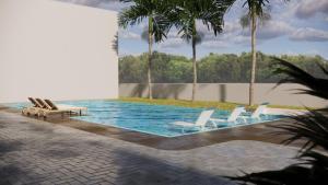 a swimming pool with lounge chairs and palm trees at Costa Atlântico House in Garopaba