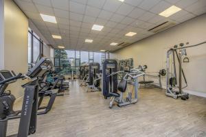 a fitness room with treadmills and cardio machines at Sandton Skye Unit 1110 in Johannesburg