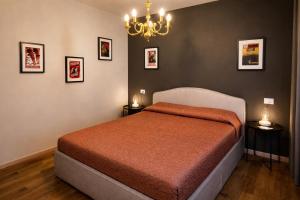 a bedroom with a bed and a chandelier at Villa Alina Family Retreat in Pietrasanta