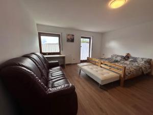 a living room with a couch and a bed at Traumhaus in Küssaberg