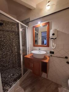 a bathroom with a sink and a shower at Suite delle Nereidi in Manarola +10 photos