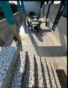a balcony with tables and chairs on a building at California Bambú in Iquitos +1 photo