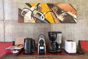 a counter with a coffeemaker and a coffee maker at Aux Buis Gourmands in La Chapelle-en-Vercors