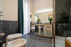 a bathroom with a sink and a toilet and a shower at DibraLuxurySuites Duomo in Milan +42 photos