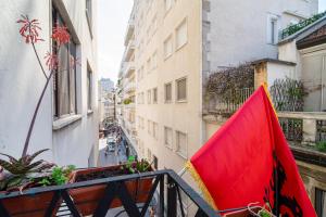 a red flag on a balcony of a building at DibraLuxurySuites Duomo in Milan