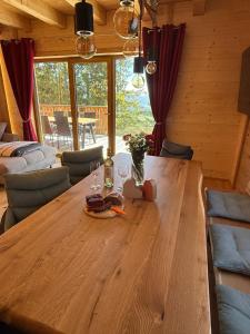 a wooden table with wine glasses on it in a cabin at Wellness Chalet Zirbitz in Lavantegg