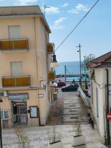 a building on a street with the ocean in the background at BrezzaMarina in Sapri