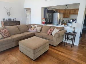 a living room with a brown couch and a kitchen at Secluded Chalet in Harrison