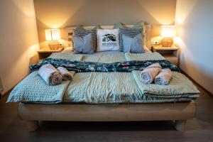a bedroom with a bed with pillows on it at Trzy Wzgórza Huwniki in Huwniki