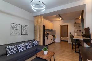 a living room with a couch and a table at Latitude 37 Luxe in Kalamata