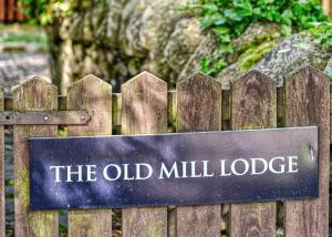 a sign for the old mill lodge on a wooden fence at Glen Clova Lodges in Angus +46 photos