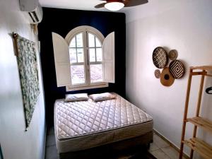 a small bedroom with a bed and a window at Sangha Urbana - hostel, yoga & meditação in Rio de Janeiro +78 photos