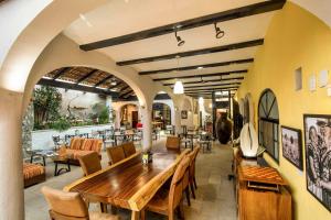 a restaurant with a wooden table and chairs at Casa del Sol Inn in Ajijic