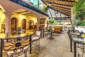 an empty restaurant with tables and chairs at Casa del Sol Inn in Ajijic