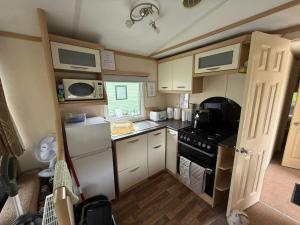 a small kitchen with white cabinets and a stove at Melrose in Lancaster