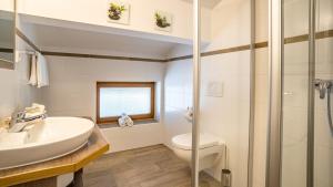a bathroom with a sink and a toilet at Gästehaus Kaindl in Reit im Winkl +54 photos