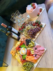 a table with two plates of food and a bottle of wine at Small Forest in Batumi