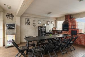 a dining room with a table and chairs and a brick oven at House with Pool in BH for Groups and Families in Belo Horizonte