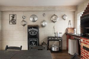 a kitchen with a table and pots and pans on the wall at House with Pool in BH for Groups and Families in Belo Horizonte