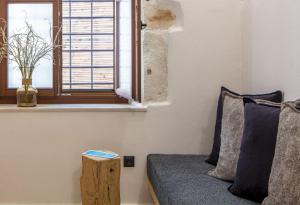a living room with a couch and a window at Margianna's Cupola Luxury Residence in Rethymno
